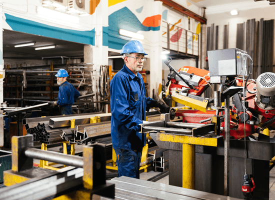 Manufacturing workers using machinery in a workshop