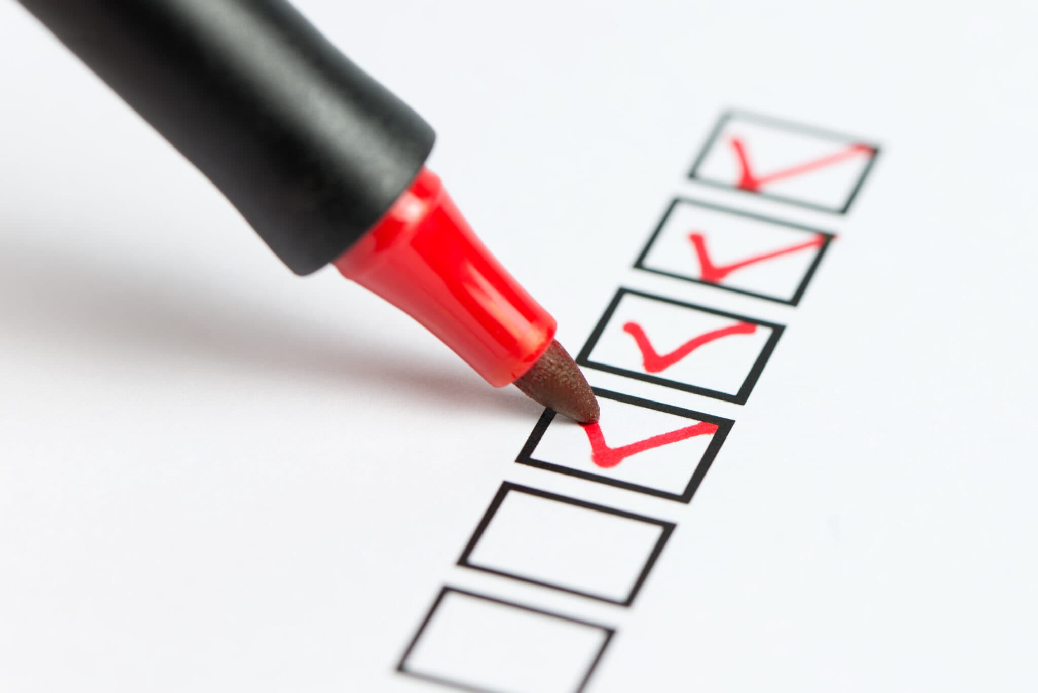A stock image of a red marker checking a box
